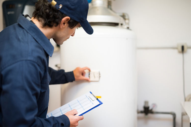 plumber inspecting a residential water heater